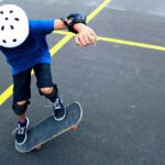 picture of child riding skateboard making tricks with skateboard safety gear