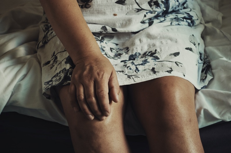 a woman holding her knee joint