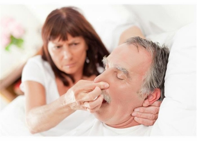 picture of a woman holding a man's nose while in bed