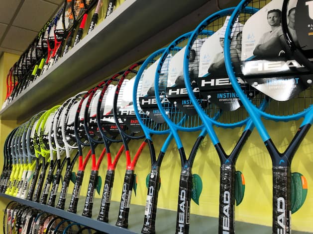 Many tennis rackets in shop