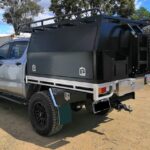 picture of an ute with a black canopy on a road