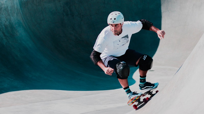 picture of a person skateboarding with helmet and knee pads