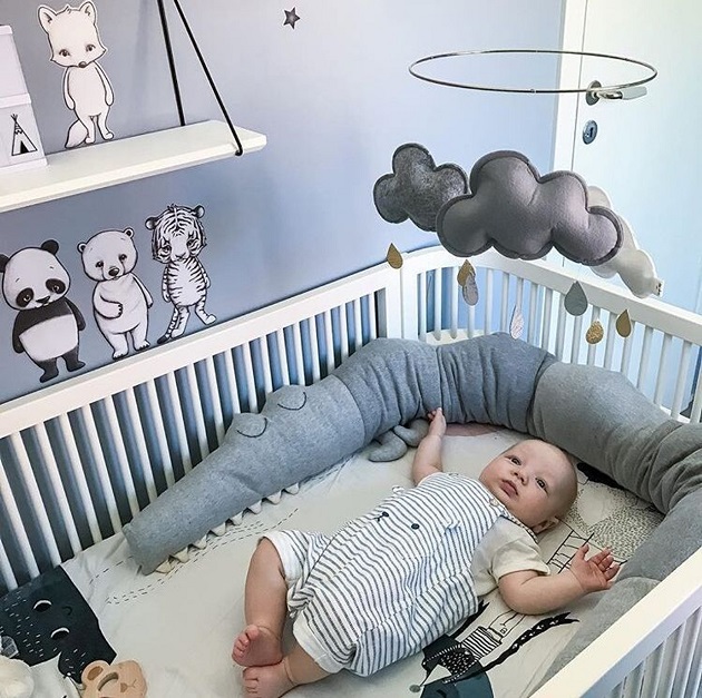picture of a baby in a crib with cute baby bedding 