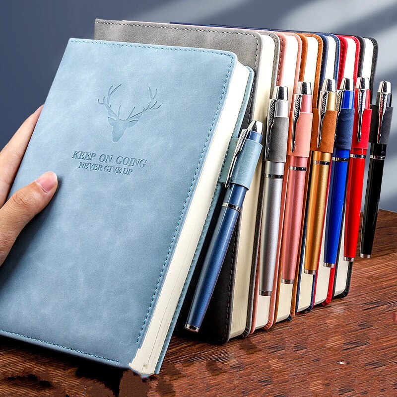 bunch of diaries with pencil with them 