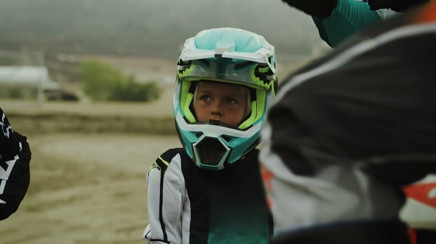 Kid wearing motorcycle helmet.