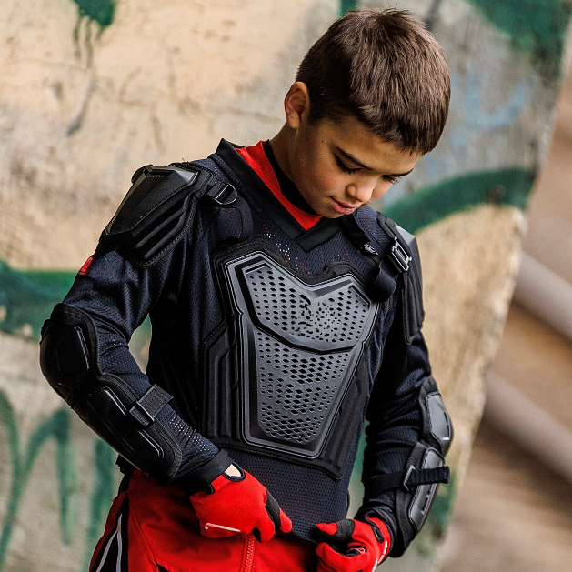 Kid put on black arm motorcycle protection on himself
