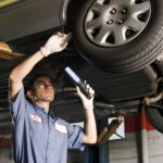 mechanic checking car air suspension