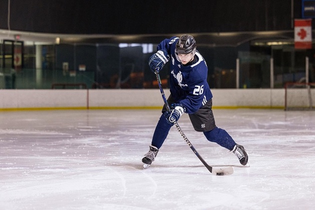 hockey player with Sherwood stick